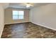 This bedroom has wood-look flooring, a window and a closet at 4006 Lawrence Daniel Dr, Matthews, NC 28104