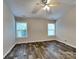 Spacious bedroom with wood-look flooring and two windows for ample natural light at 4006 Lawrence Daniel Dr, Matthews, NC 28104