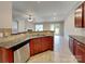 Open kitchen with stainless appliances, tiled floors, and seamless access to living area at 4006 Lawrence Daniel Dr, Matthews, NC 28104