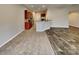 Modern kitchen open to living area, featuring stainless steel appliances and breakfast bar at 4006 Lawrence Daniel Dr, Matthews, NC 28104