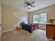 Bedroom with neutral walls, carpet flooring, ceiling fan, and a window offering plenty of natural light at 410 Deer Brush Ln, Waxhaw, NC 28173
