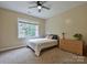 Bedroom featuring neutral walls, carpeted floors, a window, and a dresser with storage at 410 Deer Brush Ln, Waxhaw, NC 28173