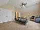 Large bonus room with a futon, desk, closet, ceiling fan, and carpet flooring at 410 Deer Brush Ln, Waxhaw, NC 28173