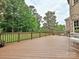 Spacious deck featuring a railing, a patio set, and a backyard with mature trees at 410 Deer Brush Ln, Waxhaw, NC 28173