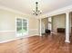 Bright dining room featuring hardwood floors, columns, and a large window at 410 Deer Brush Ln, Waxhaw, NC 28173