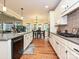 Bright eat-in kitchen showcases stainless appliances, granite counters, and access to an adjacent dining area at 410 Deer Brush Ln, Waxhaw, NC 28173