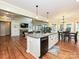 Open-concept kitchen featuring a center island, modern appliances, and seamless flow to the living and dining areas at 410 Deer Brush Ln, Waxhaw, NC 28173