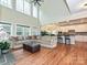 Bright living room with a soaring ceiling, large windows, hardwood floors, and cozy fireplace at 410 Deer Brush Ln, Waxhaw, NC 28173