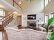 Spacious living room with fireplace, staircase, and natural lighting at 410 Deer Brush Ln, Waxhaw, NC 28173