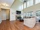 Bright living room with hardwood floors, fireplace, built-in shelving, and large windows at 410 Deer Brush Ln, Waxhaw, NC 28173