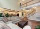 Open living room with hardwood floors, staircase, and kitchen in the background at 410 Deer Brush Ln, Waxhaw, NC 28173