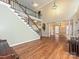 Spacious living room featuring hardwood floors and staircase to second level at 410 Deer Brush Ln, Waxhaw, NC 28173