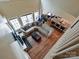 Spacious living room with hardwood floors, fireplace, and a view into the kitchen and dining areas at 410 Deer Brush Ln, Waxhaw, NC 28173