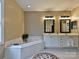 Main bathroom featuring double sinks, a large soaking tub, and neutral-toned walls at 410 Deer Brush Ln, Waxhaw, NC 28173
