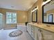 Main bathroom featuring double sinks, a soaking tub, a glass door shower, and neutral-toned walls at 410 Deer Brush Ln, Waxhaw, NC 28173