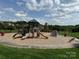 Exterior view of a playground with slides, swings, and play equipment on a mulch surface at 410 Deer Brush Ln, Waxhaw, NC 28173