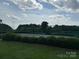 Well-maintained tennis court surrounded by greenery, offering a great space for sports and recreation at 410 Deer Brush Ln, Waxhaw, NC 28173
