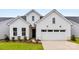 Charming new construction home with a two-car garage, black windows and door, and low maintenance landscaping at 4134 Eastover Glen Rd # 0319, Charlotte, NC 28269