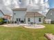 Spacious backyard with a stone patio, outdoor seating, and a well-maintained lawn at 4205 Bent Green Ln, Monroe, NC 28112
