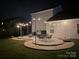 Enjoy this backyard patio featuring cafe lighting and comfortable seating on a stone patio at 4205 Bent Green Ln, Monroe, NC 28112