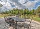 Backyard patio with outdoor seating and a view of the landscaped yard with playground at 4205 Bent Green Ln, Monroe, NC 28112