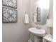 Stylish powder room with designer mirror, artwork, and pedestal sink at 4205 Bent Green Ln, Monroe, NC 28112