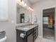 Bright bathroom with double vanity, granite countertop, and updated light fixtures at 4205 Bent Green Ln, Monroe, NC 28112
