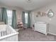 Cozy bedroom with butterflies decorations, gray carpet and dresser at 4205 Bent Green Ln, Monroe, NC 28112