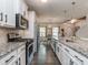 Well-equipped kitchen with stainless steel appliances, granite counters, and a view of the dining area at 4205 Bent Green Ln, Monroe, NC 28112