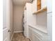 Bright laundry room with modern washer/dryer, white cabinets, and granite countertops at 4205 Bent Green Ln, Monroe, NC 28112