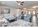 Open-concept living room connected to kitchen with an area rug, couches, and hardwood floors at 4205 Bent Green Ln, Monroe, NC 28112