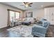 Bright living room with a sectional couch, an area rug, and butterfly wall art at 4205 Bent Green Ln, Monroe, NC 28112