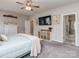 Bright main bedroom with a large TV, dresser, and access to the bathroom at 4205 Bent Green Ln, Monroe, NC 28112