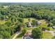 Stunning aerial view capturing the property, surrounded by dense trees and picturesque landscapes at 425 Troutman Rd, Rockwell, NC 28138