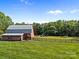 Well-maintained barn set against a backdrop of open fields and scenic trees at 425 Troutman Rd, Rockwell, NC 28138