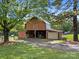 Large barn surrounded by mature trees and ample space at 425 Troutman Rd, Rockwell, NC 28138
