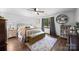 Inviting bedroom features stylish furnishings, including a decorative bench and a curated bookshelf, for a cozy retreat at 425 Troutman Rd, Rockwell, NC 28138