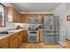 Well-equipped kitchen features stainless steel appliances, wooden cabinets, and hardwood floors, ready for culinary adventures at 425 Troutman Rd, Rockwell, NC 28138