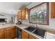 A well-lit kitchen featuring wood cabinets, a modern sink, and a view of the outdoors, offering a functional space at 425 Troutman Rd, Rockwell, NC 28138
