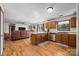 Open kitchen with an island bar, stainless steel appliances, and hardwood floors at 425 Troutman Rd, Rockwell, NC 28138