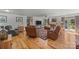 Spacious living room with hardwood floors, leather sofas, and French doors to the backyard at 425 Troutman Rd, Rockwell, NC 28138
