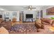 Comfortable living room featuring hardwood floors, leather furniture, and a large area rug at 425 Troutman Rd, Rockwell, NC 28138