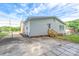 View of house with white siding, concrete patio, and a wooden staircase leading to the back door at 4500 Ridgeley Dr, Charlotte, NC 28208