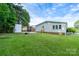 Spacious backyard with lush green grass and a storage shed at 4500 Ridgeley Dr, Charlotte, NC 28208