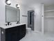 Well-lit bathroom with a dual sink vanity, modern fixtures, and a glass-enclosed shower at 4500 Ridgeley Dr, Charlotte, NC 28208