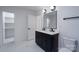 Beautiful bathroom with dual sink vanity, modern fixtures, and a walk-in closet at 4500 Ridgeley Dr, Charlotte, NC 28208