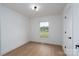 Cozy bedroom with a picture window, white trim, wood-look flooring, and contemporary lighting at 4500 Ridgeley Dr, Charlotte, NC 28208