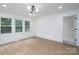 Bright bedroom boasts wood-look flooring, ample windows, and a modern light fixture for a stylish touch at 4500 Ridgeley Dr, Charlotte, NC 28208