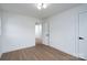Modern bedroom offers wood-look flooring, a contemporary light fixture, and a bright, neutral color scheme at 4500 Ridgeley Dr, Charlotte, NC 28208