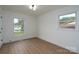 Bright bedroom features wood-look flooring, white trim, and windows with a neighborhood view at 4500 Ridgeley Dr, Charlotte, NC 28208